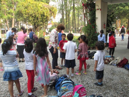 Greeting the teacher before running off to the football / soccer field.