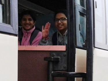Meghna and I waved goodbye to our parents from the bus.