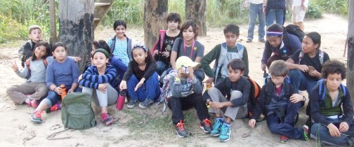 Resting in the shade during a long hike.  Everyone's wearing long sleeves and long pants because of the mosquitoes.
