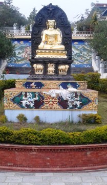 Golden Buddha statue in the garden of the monastery.